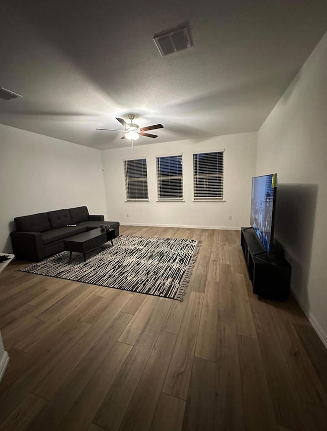 Living room featuring visible vents, baseboards, c