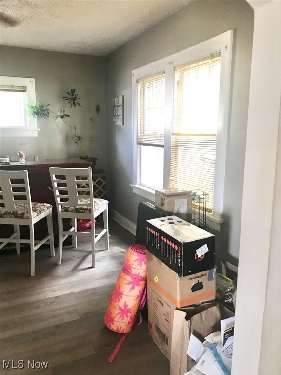 Dining area with dark wood finished floors and a textured ceiling