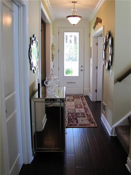 Entry way with decorative custom glass door.
