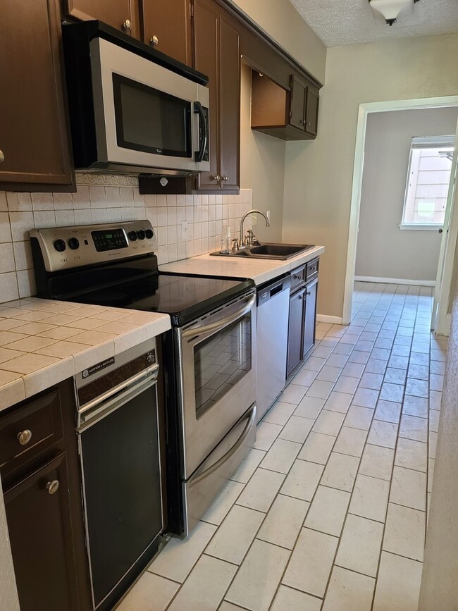 Open Kitchen view with stainless steal appliances.