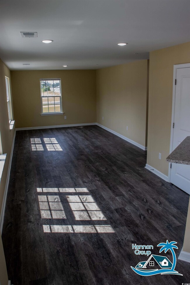 Spare room with dark hardwood / wood-style floorin