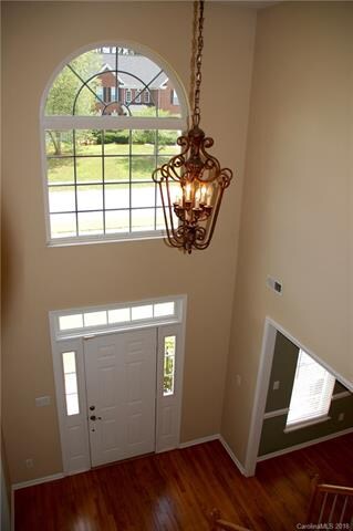Two story foyer with hardwood flooring
