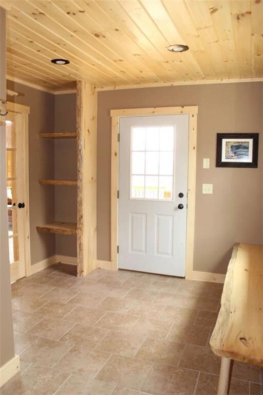 Mud room upon entry with tile floors