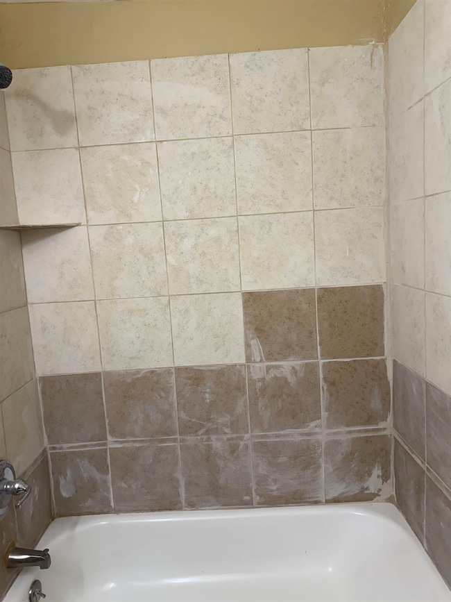 Full bath featuring bathing tub / shower combination