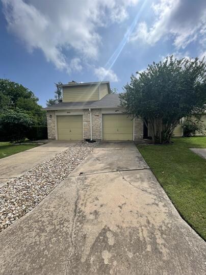 View of front of property with concrete driveway,