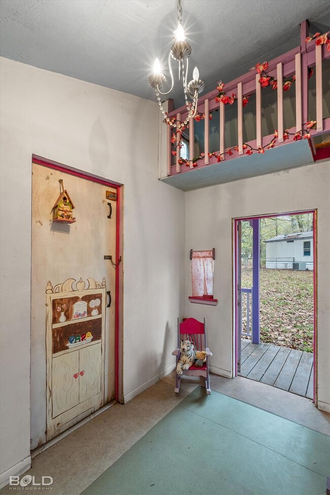 Doorway featuring a textured ceiling and an inviti