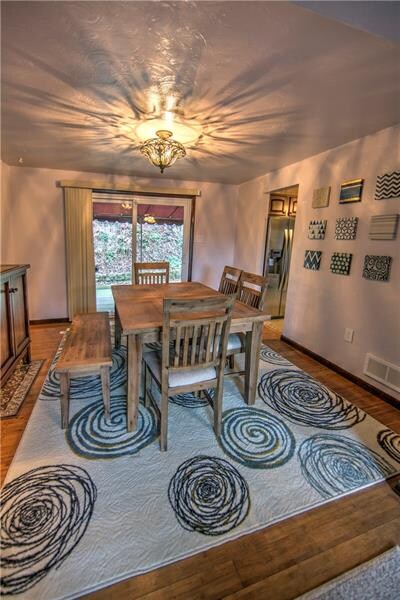 Dining room with bamboo floors and sliding glass d