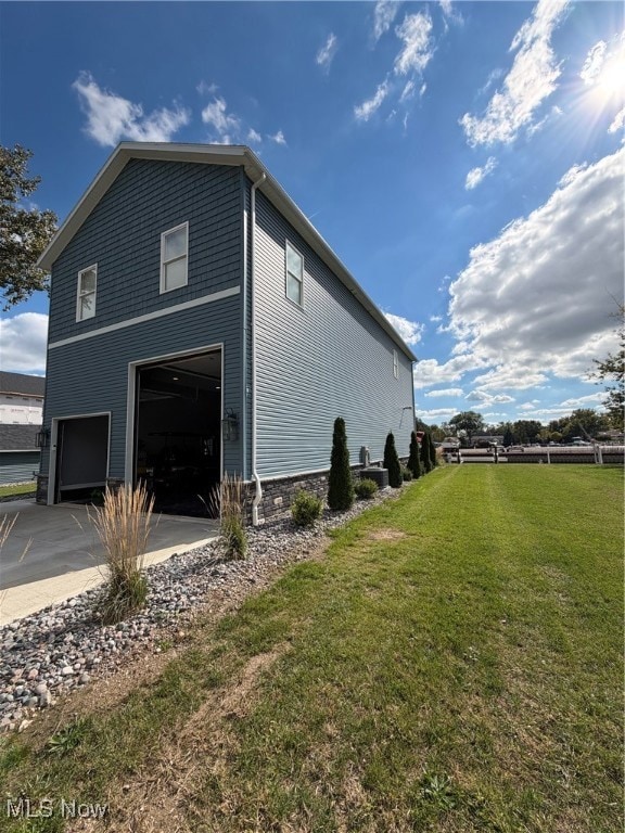 View of home's exterior with a garage and concrete driveway