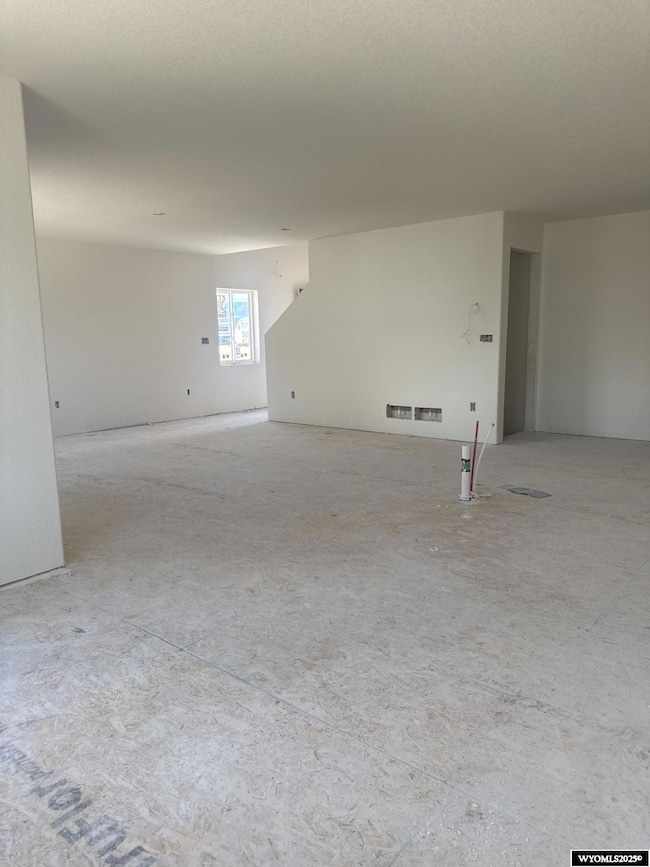 Looking from kitchen through the dining room towards the front door.
