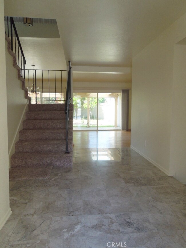 Formal entry with marble floors and stairs with wrought iron railing. Includes large guest closet too.