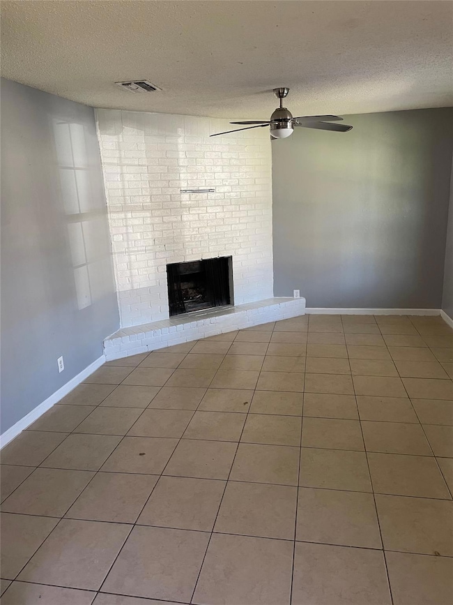 Unfurnished living room featuring a textured ceil