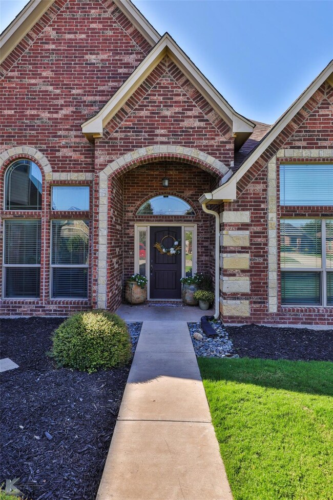 View of exterior entry featuring a lawn