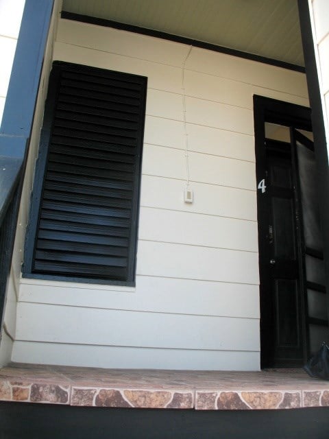 Front door for unit 4 and the window has shutters
