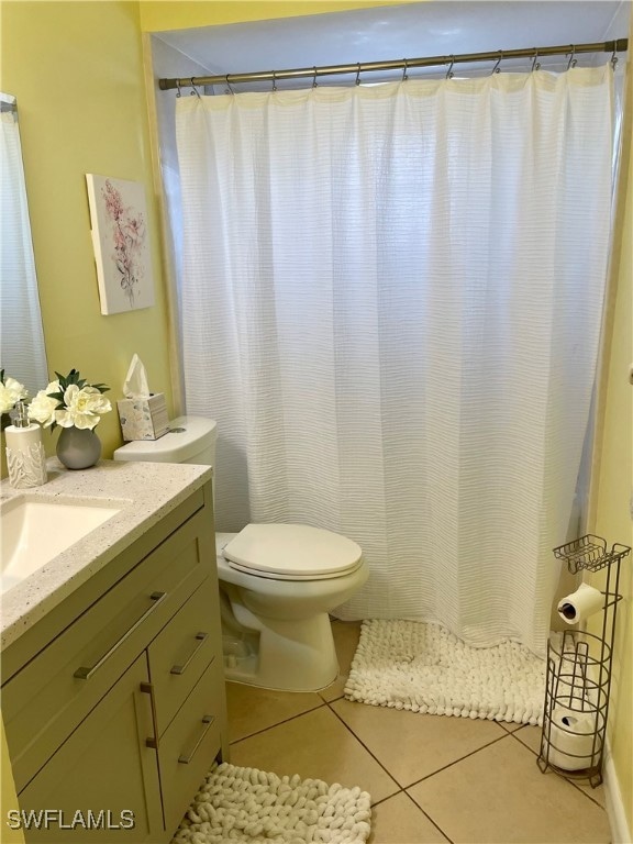 Full bath with vanity, tile patterned flooring, an