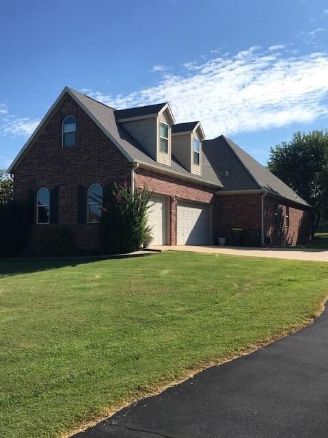 This beautiful brick home has a very large 3-car garage and concrete slab entryway.