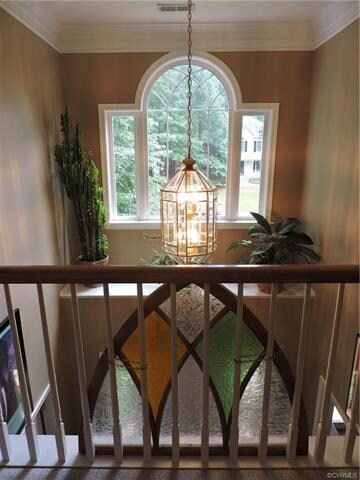 Lovely 2-story foyer with decorator shelf.