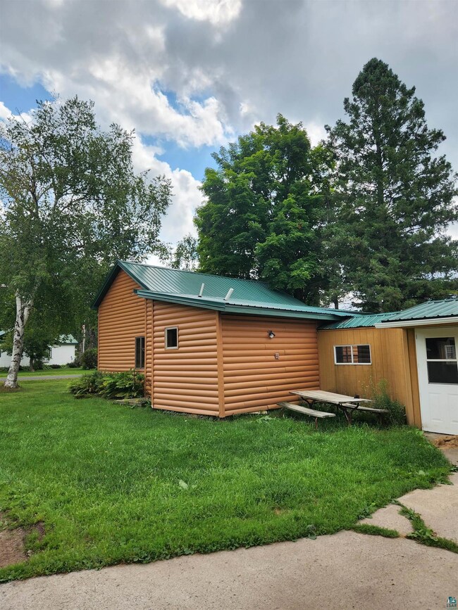 View of side of home with a lawn
