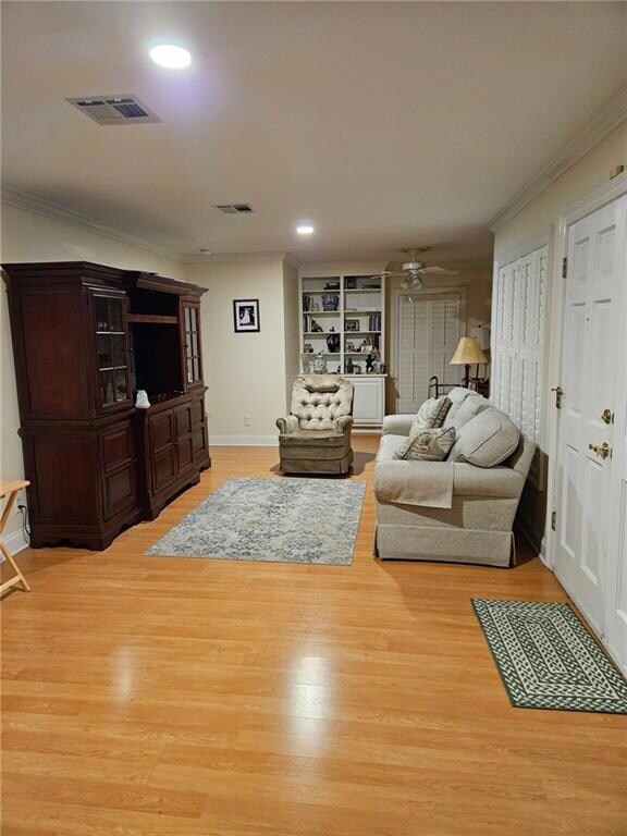 Living room with build in bookcases and office are