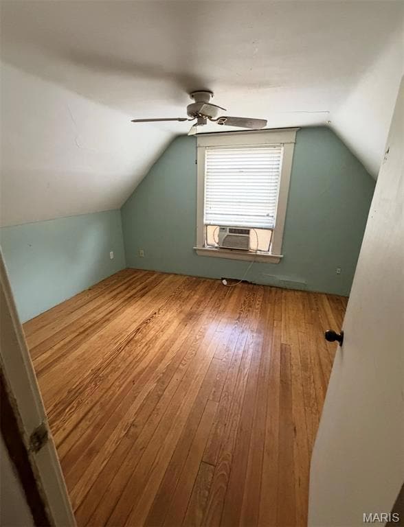 Bonus room with lofted ceiling, hardwood / wood-style flooring, and cooling unit