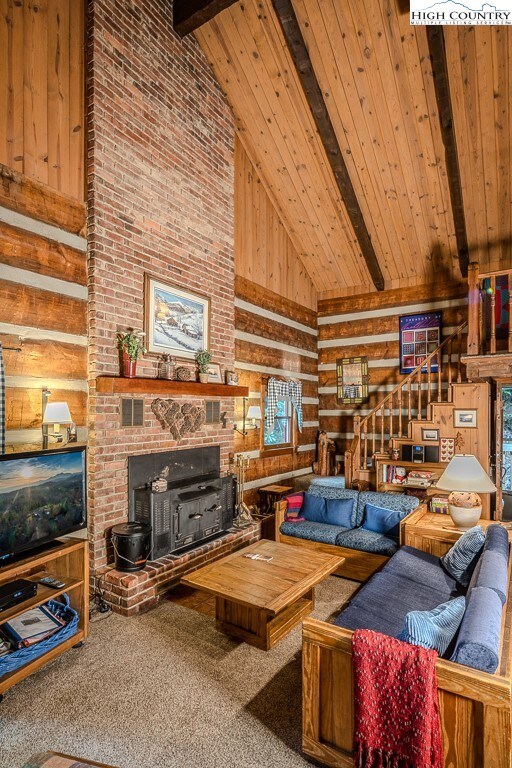 Soaring ceilings, handsome brick fireplace with wo