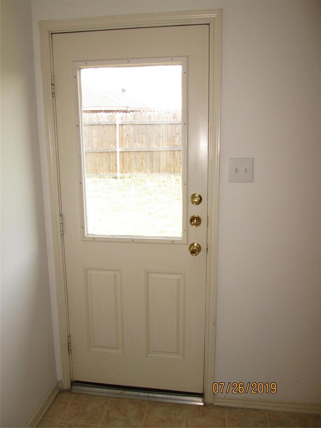 Entryway with light tile patterned flooring