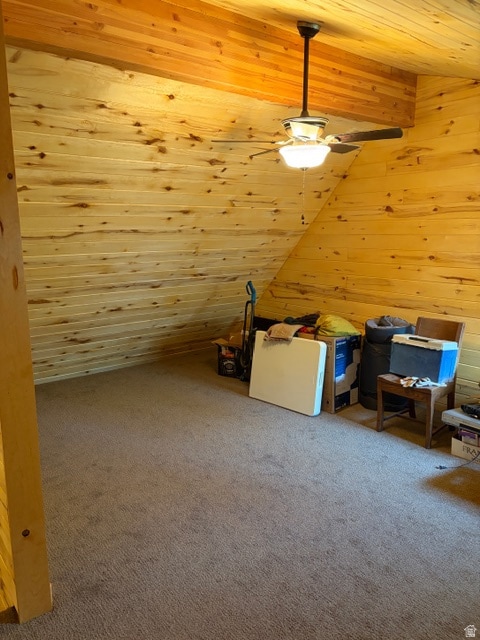 Bonus room featuring wood ceiling, wooden walls, carpet floors, and vaulted ceiling