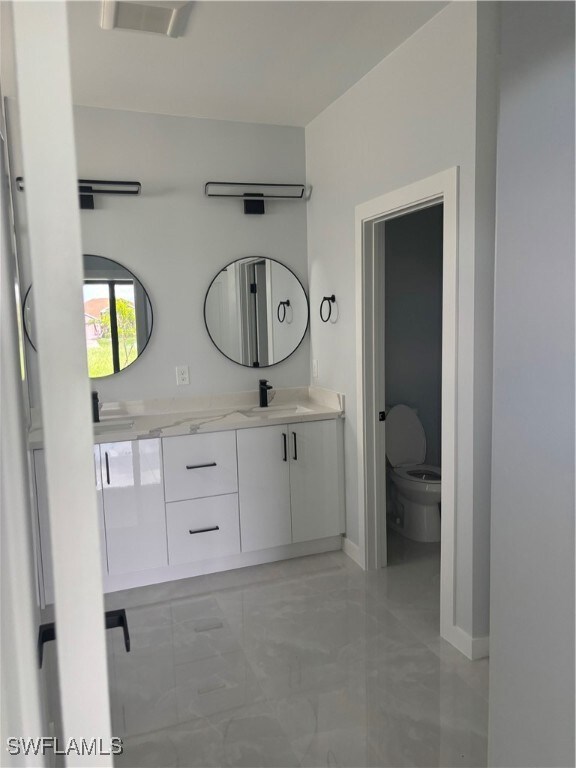 Full bathroom with marble look tile flooring and d