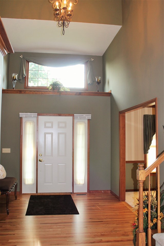 Spacious foyer with hardwood floors.