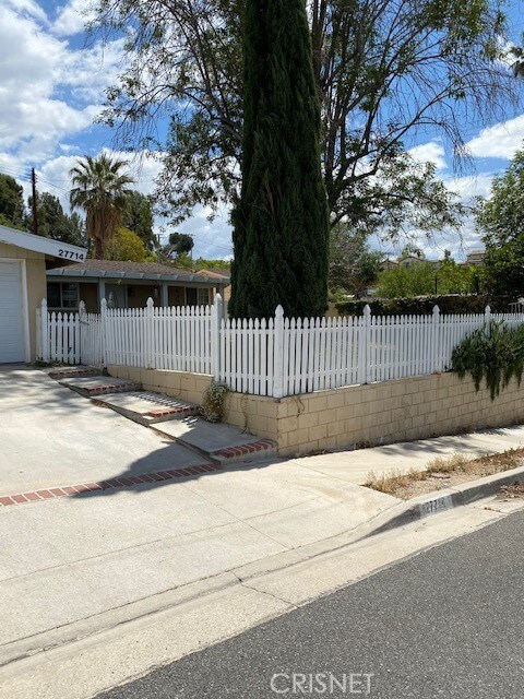Front yard with white picket fence.
