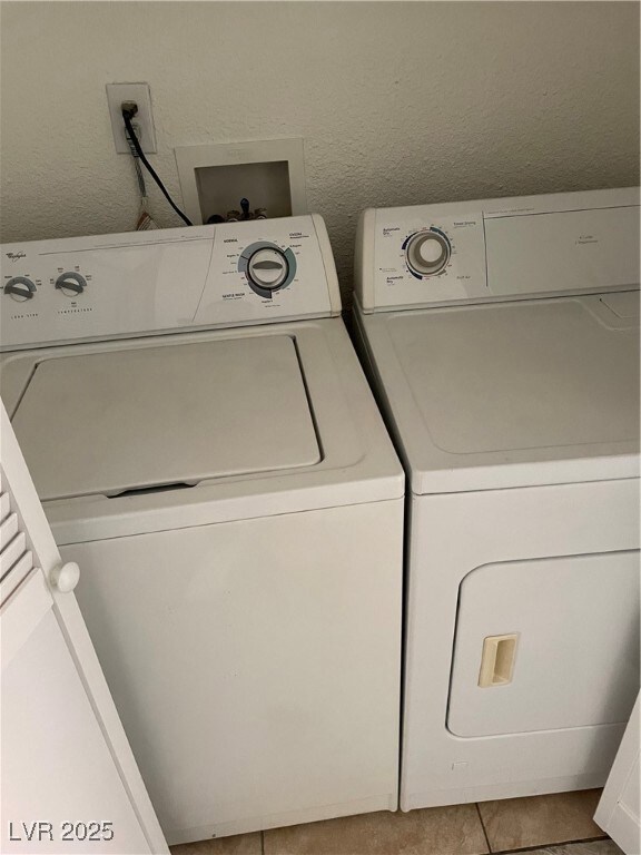 Laundry room featuring washer and clothes dryer an