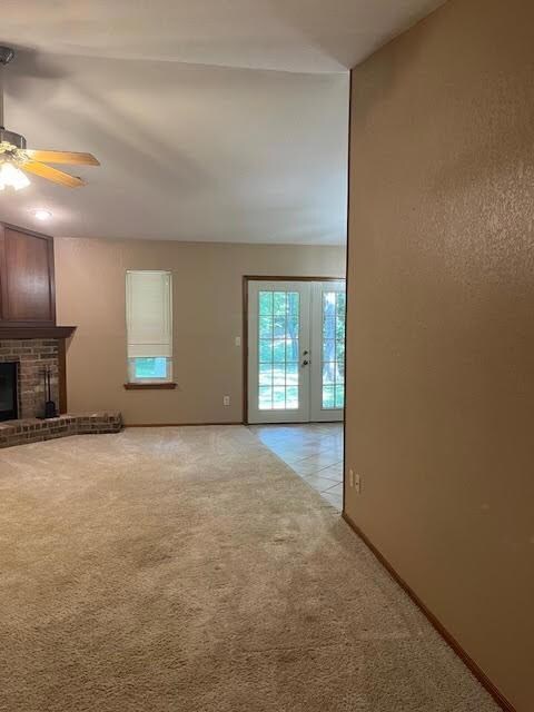 Unfurnished living room featuring light carpet, a 