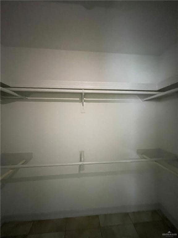 Spacious closet with tile patterned floors