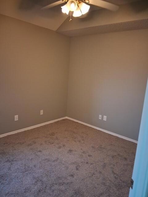 Carpeted empty room featuring baseboards and ceili