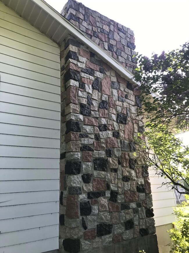 Stone chimney and side of house