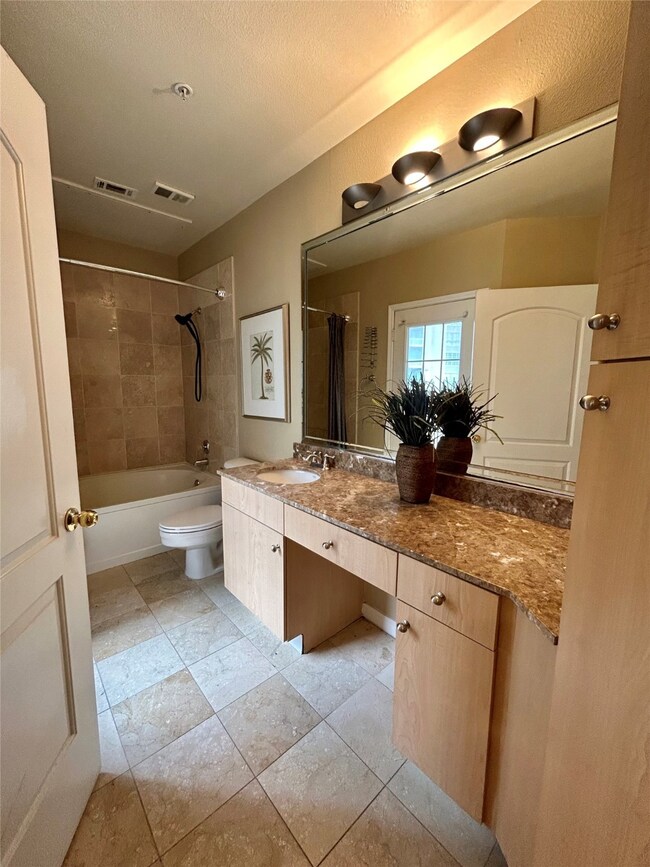 Bathroom with shower / bath combination with curtain, vanity, a textured ceiling, and light tile patterned floors