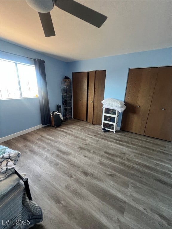 Bedroom with two closets, wood finished floors, ba