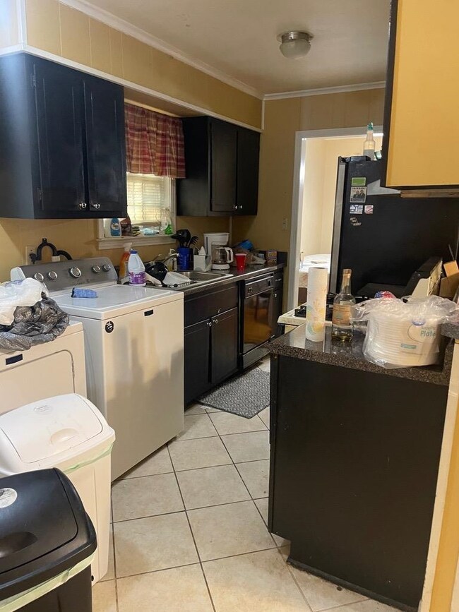 Kitchen with washing machine and dryer, refrigerat