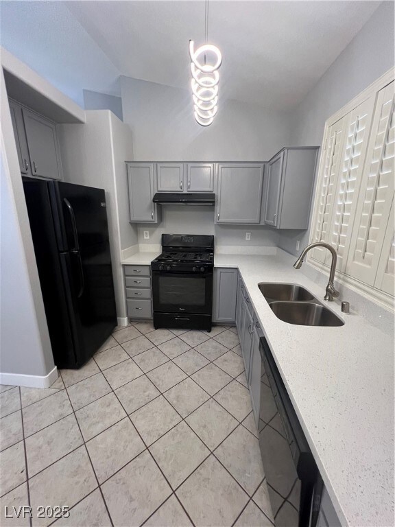 Kitchen featuring gray cabinets, black gas stove,