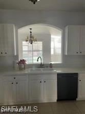 Kitchen with black dishwasher, light countertops,