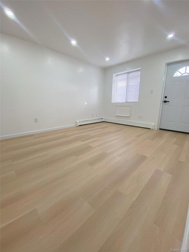 Entryway with light wood-type flooring, recessed lighting, and a baseboard radiator