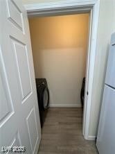 Laundry area with washer / dryer and light wood finished floors