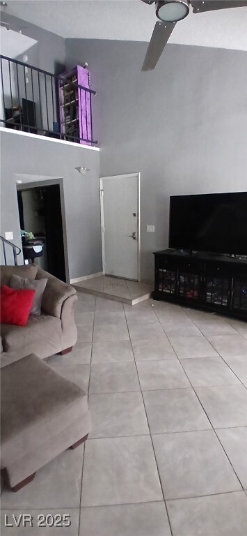 Living area with a towering ceiling and tile patte