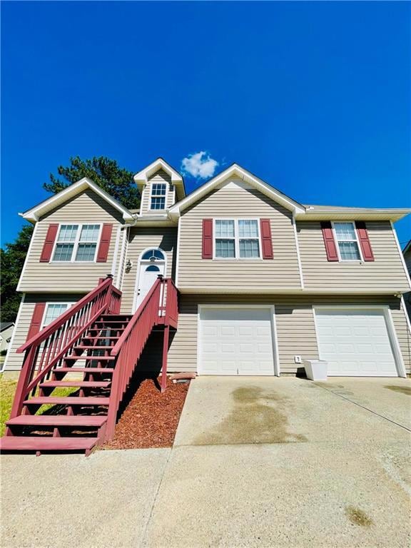 Split foyer home featuring an attached garage and driveway