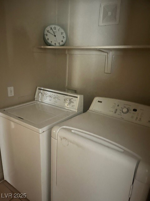 Clothes washing area with visible vents, washer an