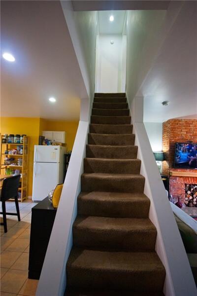 Stairs to the second floor.  Also showing the flow
