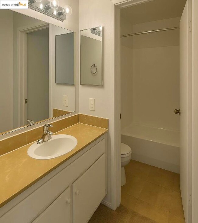 Full bath featuring vanity, shower / washtub combination, and tile patterned floors