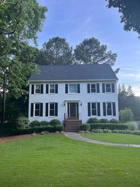 Colonial home with a front lawn