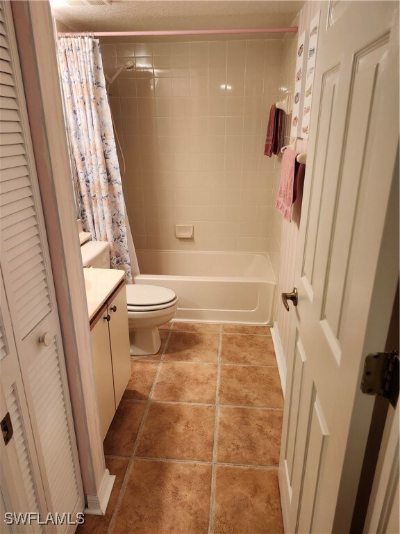Full bathroom featuring tile patterned floors, toi