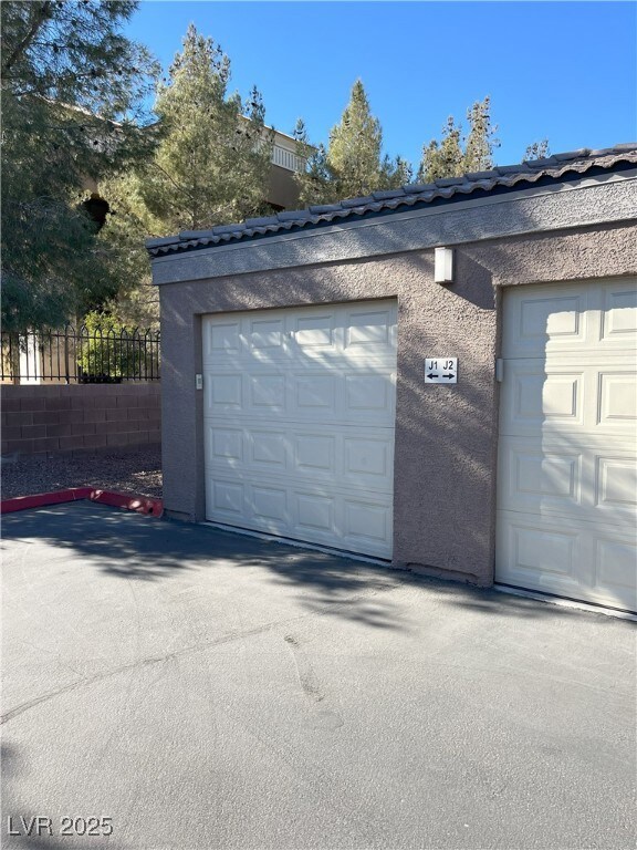 Garage featuring fence