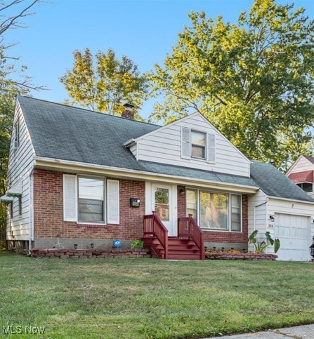 View of front of home featuring an attached garage, a front yard, brick siding, a shingled roof, and a chimney